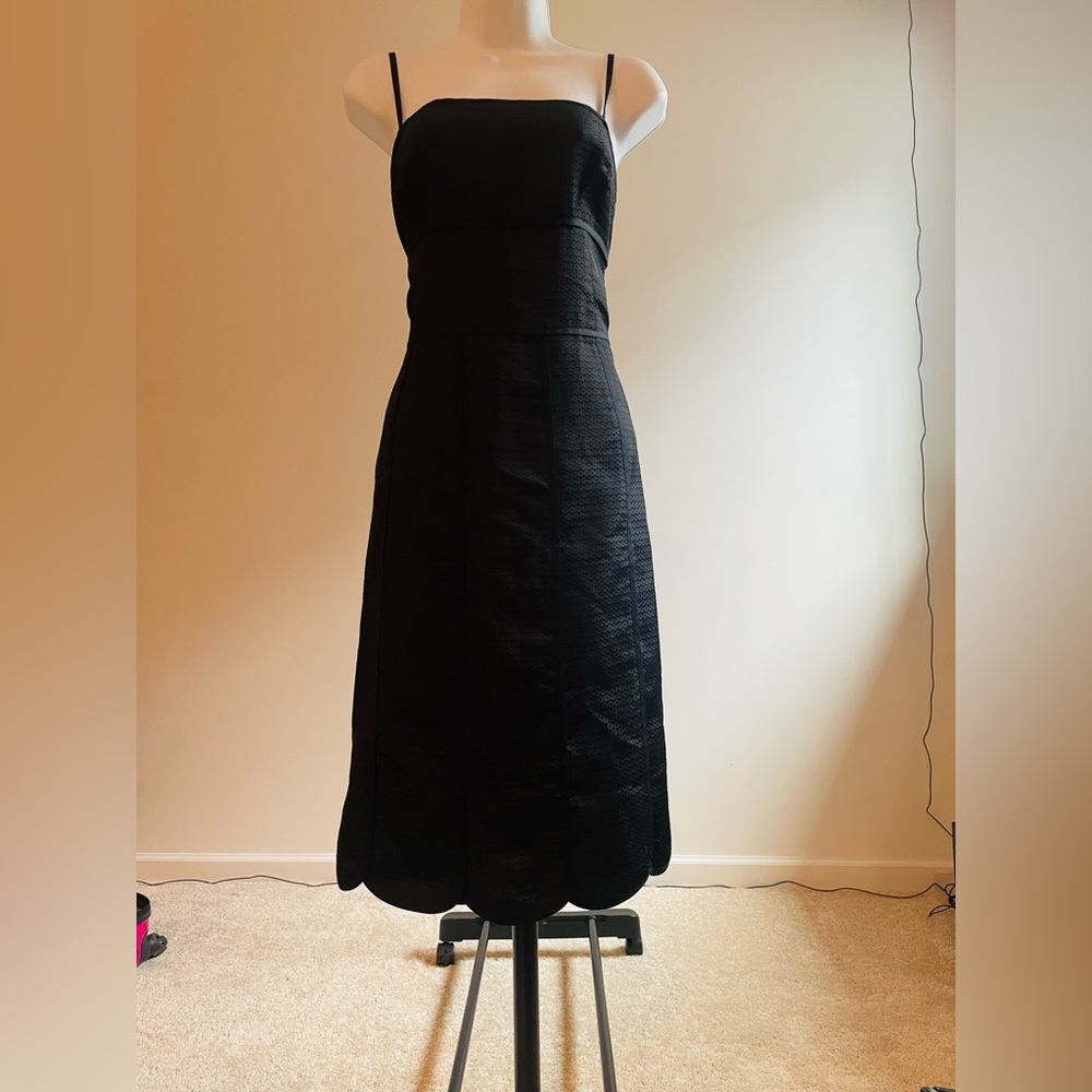 Beautiful and elegant strap black dress..Zipper on the right side. Knee length